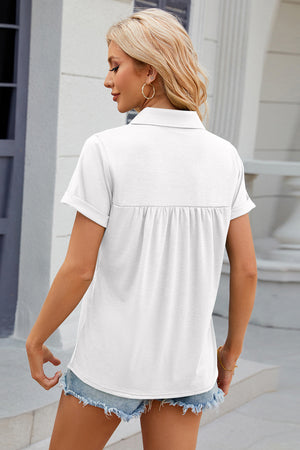 White polo top with short sleeves and gathered yoke detail.