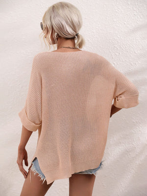 Relaxed knit tunic top in ivory with boat neck and cuffed short sleeves.