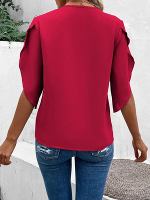 Deep red blouse with scalloped lace trimmed flutter sleeves and a V-neck.
