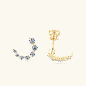 Gold Celestial Arc Moissanite Earrings with sparkling stones in a curved design.