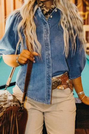 Denim maternity blouse with voluminous puff sleeves, collared neckline, and button-down front.