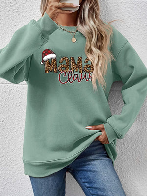 Sage green crewneck sweatshirt with leopard print "Mama Claus" graphic and Santa hat detail.