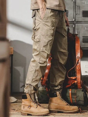 Men's khaki cargo jogger pants with multiple pockets and zippered ankles.