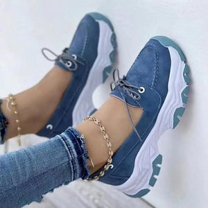 Blue suede lace-up sneakers with a chunky white sole and round toe.