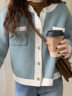 Blue acrylic button up cardigan with white contrast trim and pockets