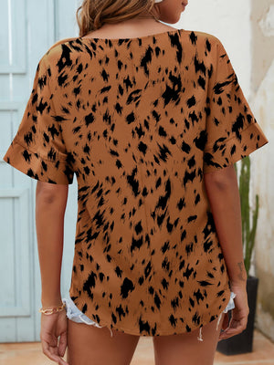 Brown dalmatian print relaxed fit blouse with notch neck and cuffed short sleeves.