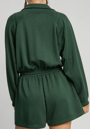 Dark green drawstring waist romper with funnel neck and long sleeves.