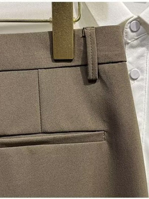 Men's brown chino shorts detail view, showing waistband, belt loop, and pocket.