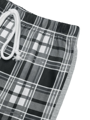 Plaid wide-leg track pants in black with white and grey plaid pattern and grey side stripe.