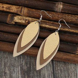 Layered tan leatherette statement earrings with hook backs.