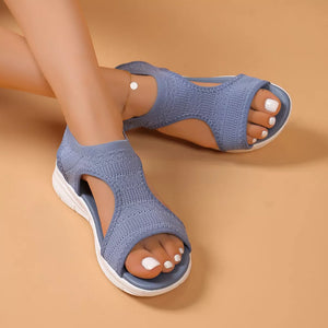 Sky blue open-toe platform sandals with white soles and a knit upper.