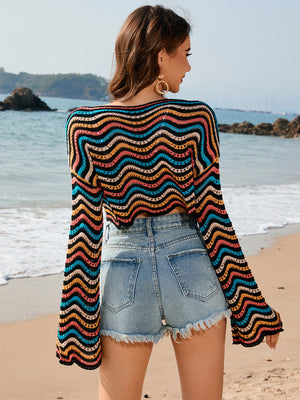 Multicolor wave-stripe crochet cropped sweater with bell sleeves.