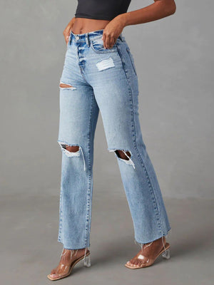 Light wash denim wide leg jeans with distressed knee rips and button fly.