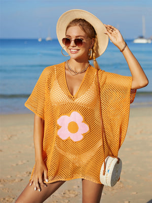 Orange crochet beach cover-up with pink and orange flower appliqué, V-neck, short sleeves.