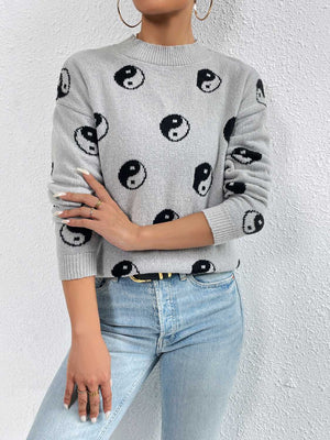 Heather gray knit sweater with all-over black yin yang pattern, crew neck, drop shoulders, and long sleeves.