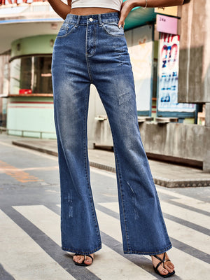 Dark blue denim flare jeans with distressed details and a buttoned fly.