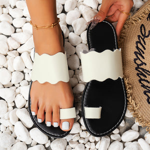Sophisticated white toe loop sandals with scalloped straps on black soles.