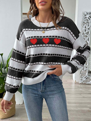 Black and white striped knit sweater with embroidered red hearts, crew neck, long sleeves.