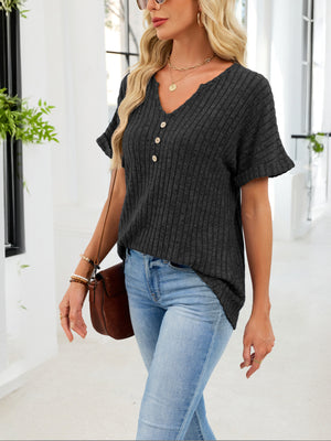 Black ribbed knit short sleeve t-shirt with V-neck and decorative buttons, curved hem.