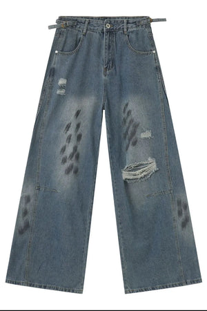 Medium wash relaxed fit denim jeans with distressed details and graphic print.
