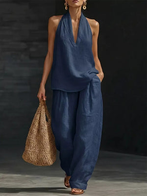 Dark blue halter neck top and wide-leg pants set with a V-neck and flowing silhouette.