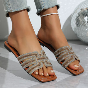 Brown open-toe sandals with dazzling rhinestone embellishments on straps.
