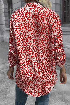 Women's oversized shirt in deep red with abstract spot print, buttoned front, and long sleeves.