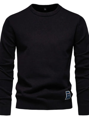 Black crew neck knit sweater with a small logo patch on the hem.