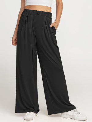 Black pleated palazzo trousers with pockets and elastic waist.
