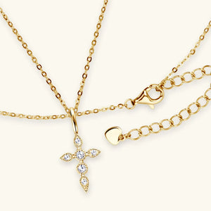 Gold diamond-set cross pendant necklace with adjustable chain and lobster clasp.