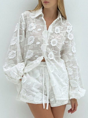 White embroidered two-piece set with button-down shirt and shorts featuring floral applique and balloon sleeves.