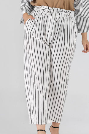 White paperbag waist trousers with black vertical stripes and a tie belt.
