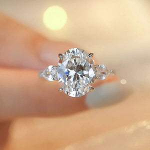 Dazzling Moissanite oval ring in sterling silver with side stones.