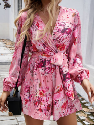Floral wrap romper in Dusty Pink with blouson sleeves and a tie waist.