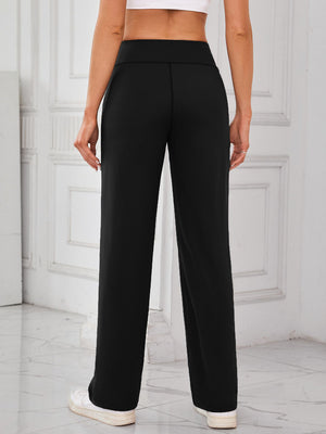 Black wide-leg lounge trousers with patch pockets, featuring a relaxed fit and casual style.