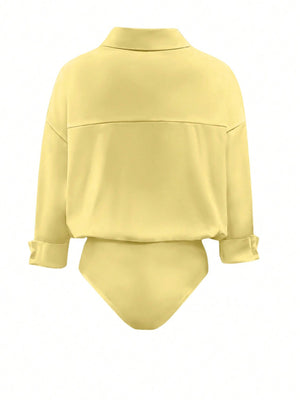Yellow collared long sleeve bodysuit with cuffed sleeves and a button-down detail.