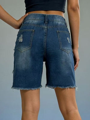 Distressed dark blue denim shorts with frayed hem and ripped details.