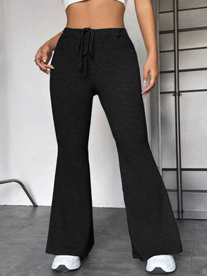 Black flare leg lounge trousers with drawstring waist and pockets.