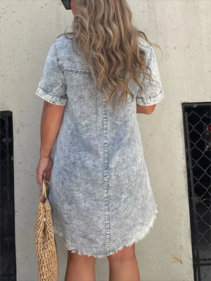 Grey denim short sleeve dress with frayed hem and a relaxed fit.