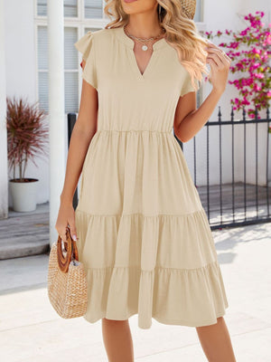 Tan ruffled midi dress with notched V-neck and tiered skirt.