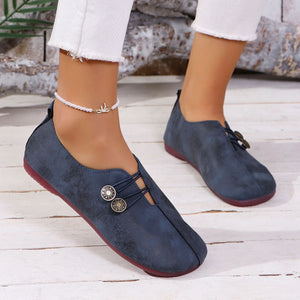 Blue casual round-toe flats with decorative buttons and elastic laces.