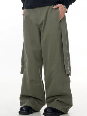 Army green wide-legged cargo pants with buttoned flap pocket detail.