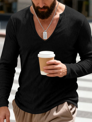 Black ribbed long sleeve t-shirt with deep V-neck, worn by a man holding a coffee cup.