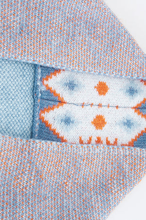 Blue knit cardigan with geometric trim detail and flecked texture.