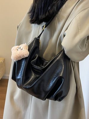 Medium black pu leather crossbody bag with chain detail and fluffy charm