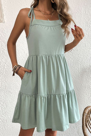 Light green tie-strap mini dress with ruffle hem and pockets