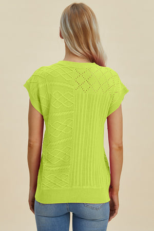 Lime green knit patchwork top with cable and diamond patterns, short sleeves.