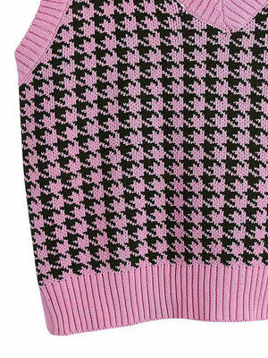 Houndstooth knit v-neck tank top in pink and black with ribbed hem.