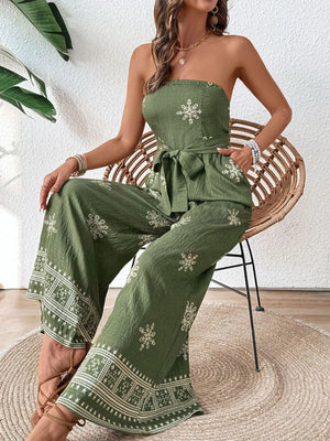 Bandeau jumpsuit in matcha green with white embroidery and wide legs.