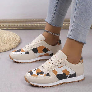 Leopard print panel runner sneakers in ivory with lace-up closure and athletic sole.